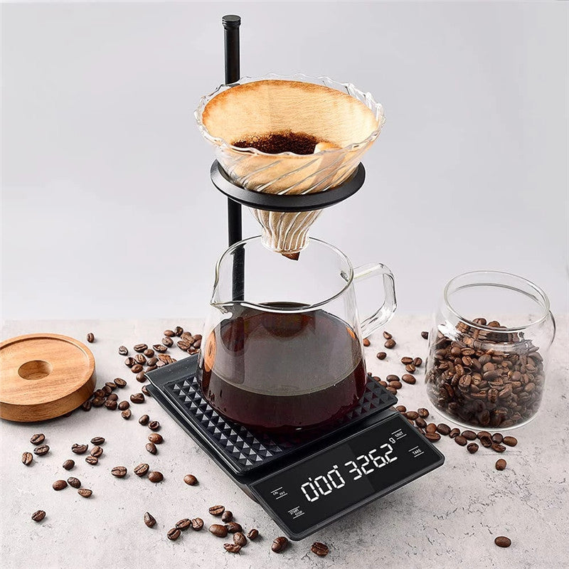 Coffee scale with timer weighing a pour-over brew in progress with glass carafe